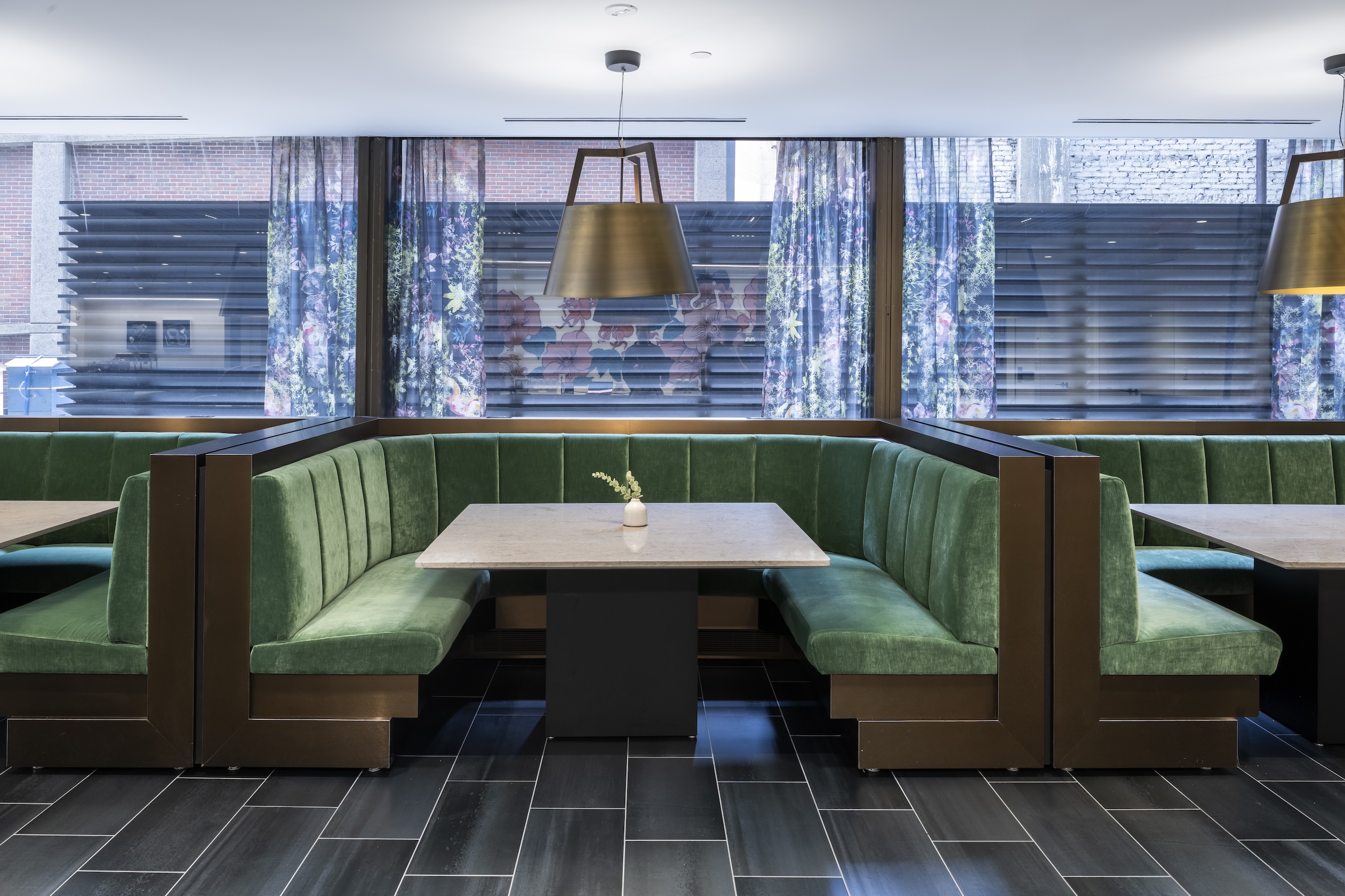 Green banquette seating in Convene Gallery