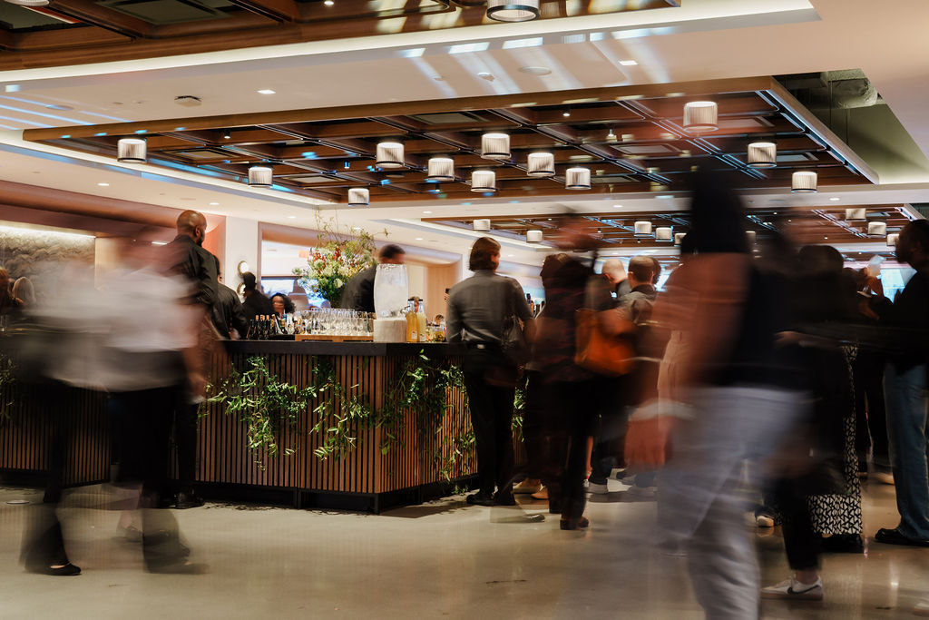 People blurred moving around bar in Convene 30 Hudson Yards event venue